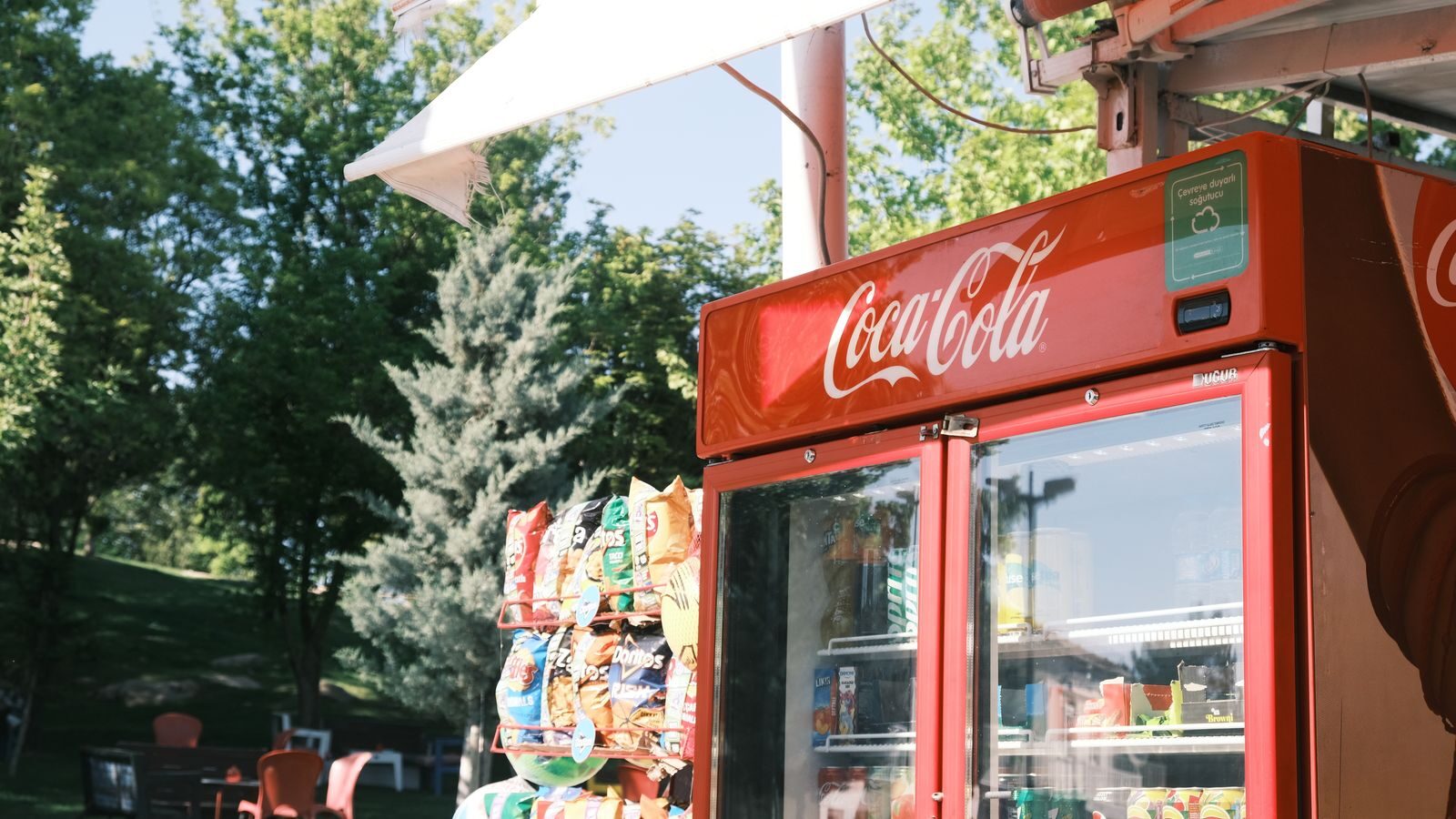 Glass-door beverage coolers and merchandisers in a convenience store